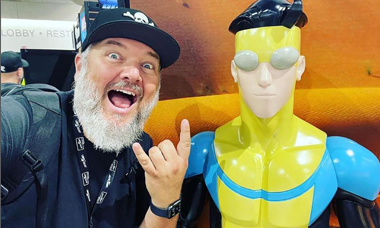 Shawn Kirkham and an Invincible statue at Comic-Con International: San Diego 2022