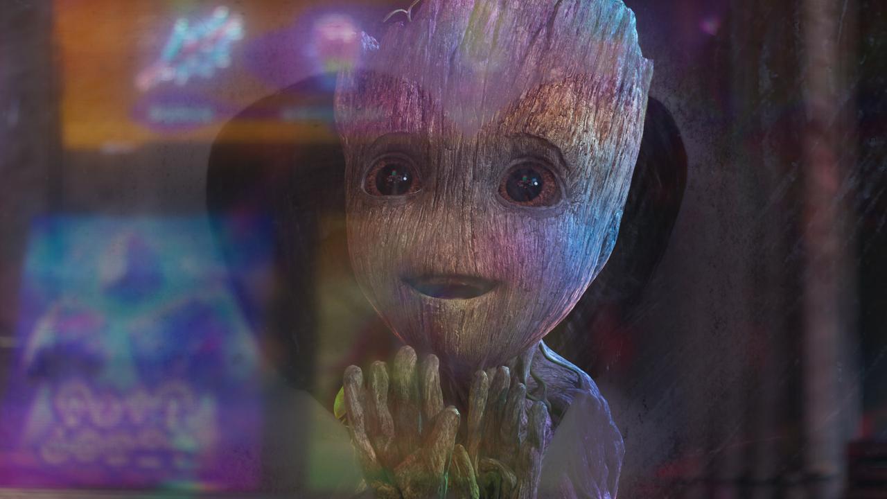 Still image featuring baby groot looking through a heartshaped space on glass