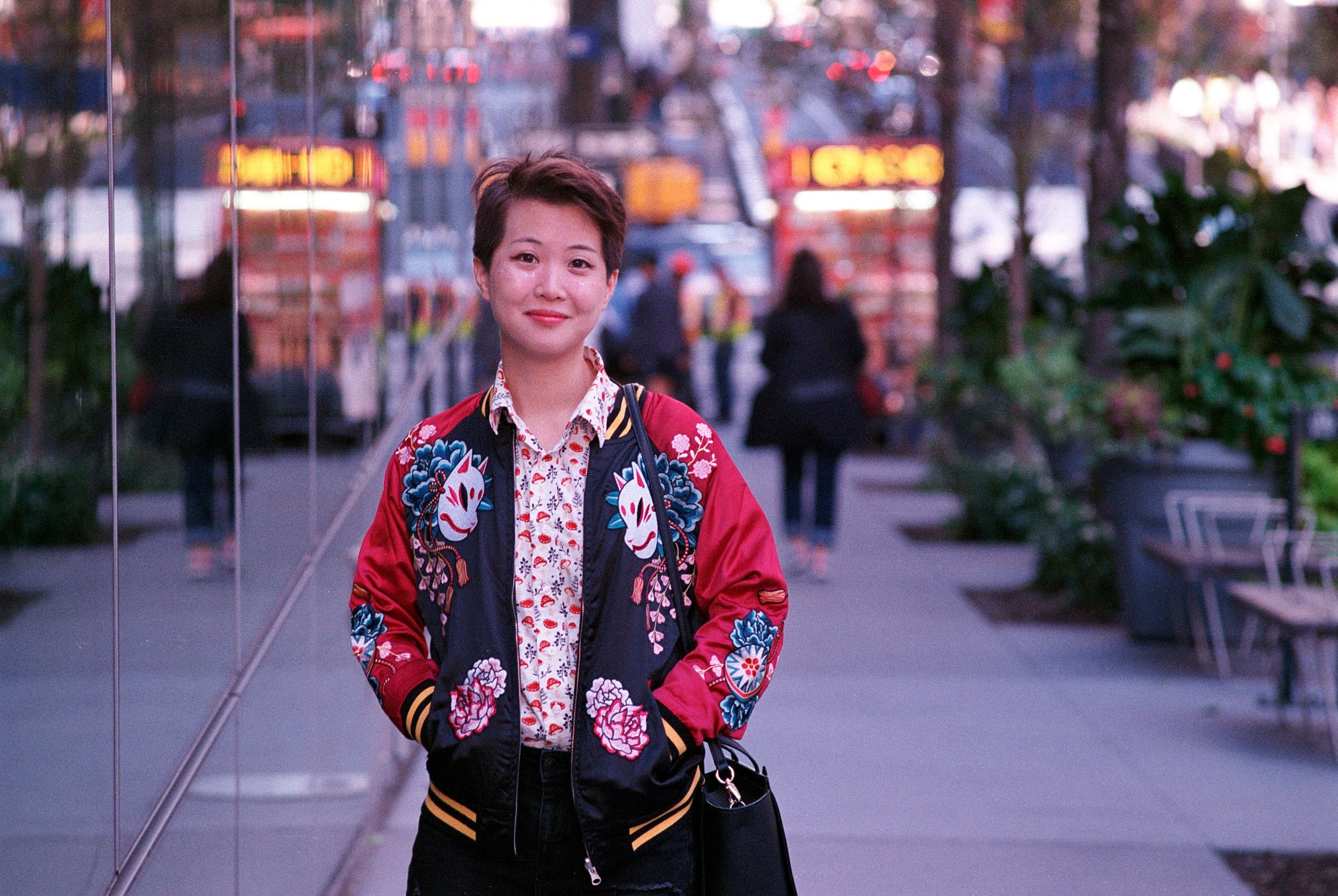 A color portrait of Alyssa Wong, hands in pockets
