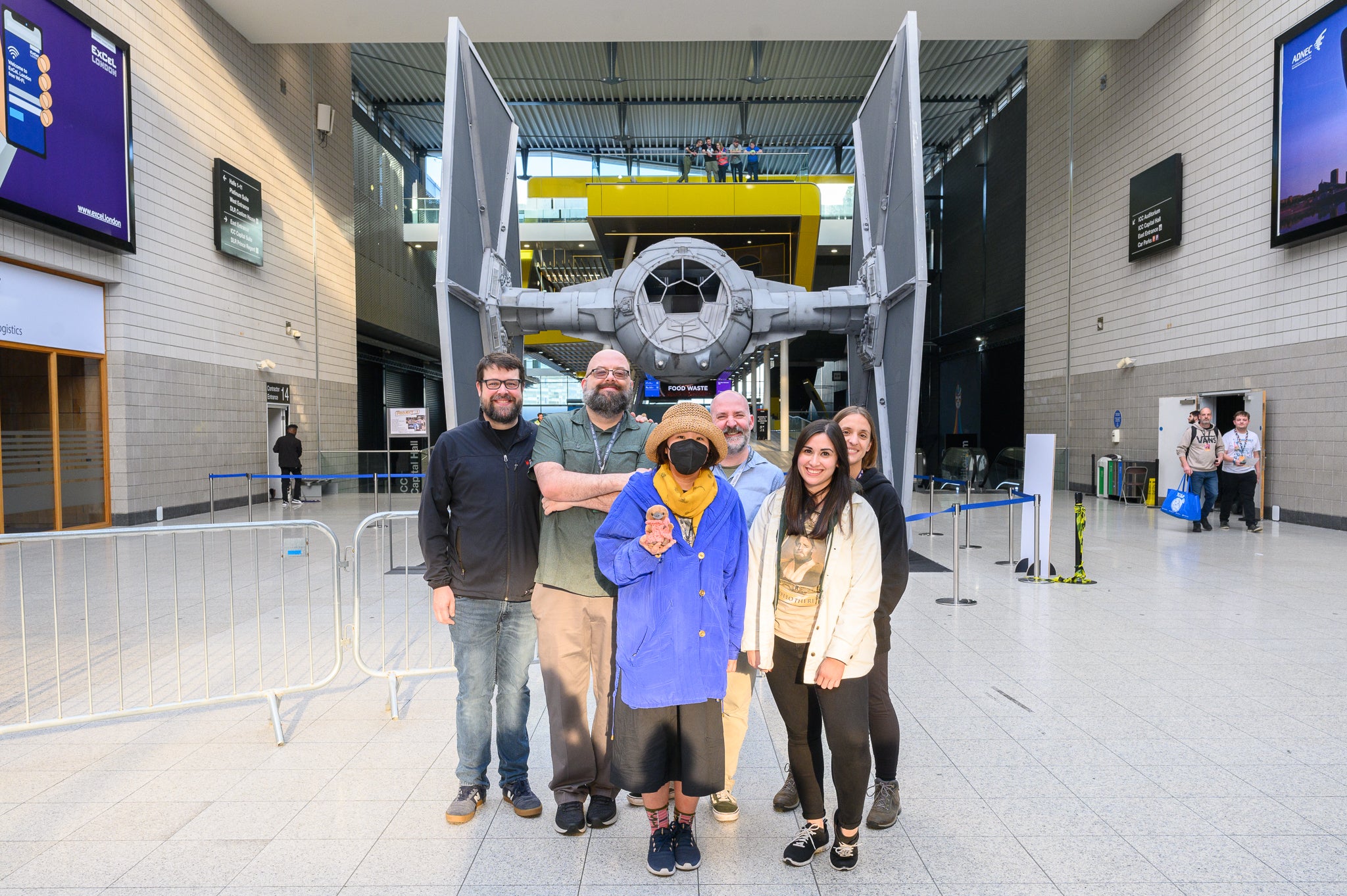 Photograph of Popverse team in front of a Tie Fighter