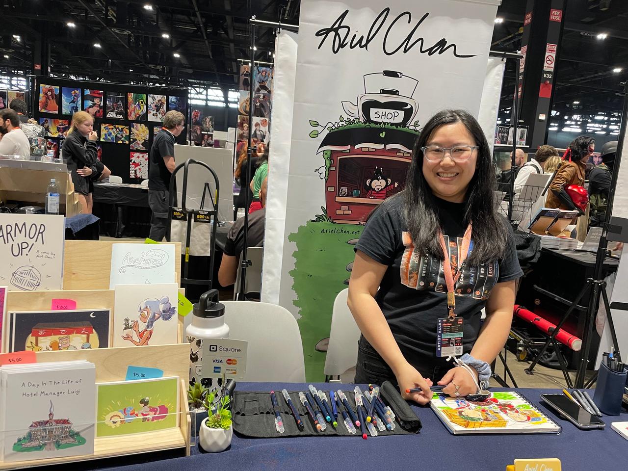 Ariel Chan standing in front of book