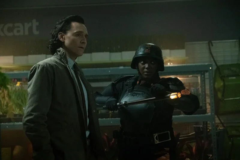 Still image of Loki and TVA agent looking in the same direction