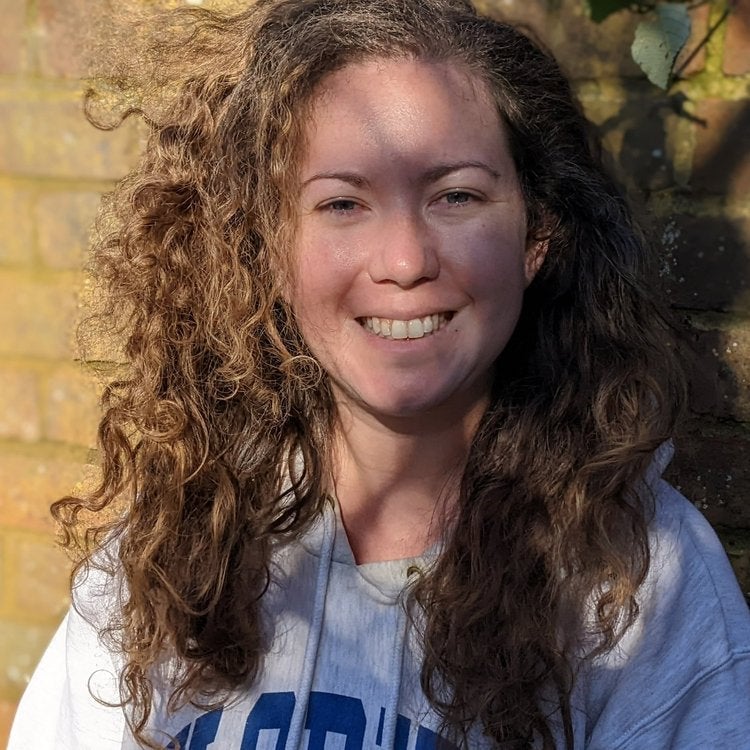 Headshot of Meghan Fitzmartin smiling and wearing a hoodie
