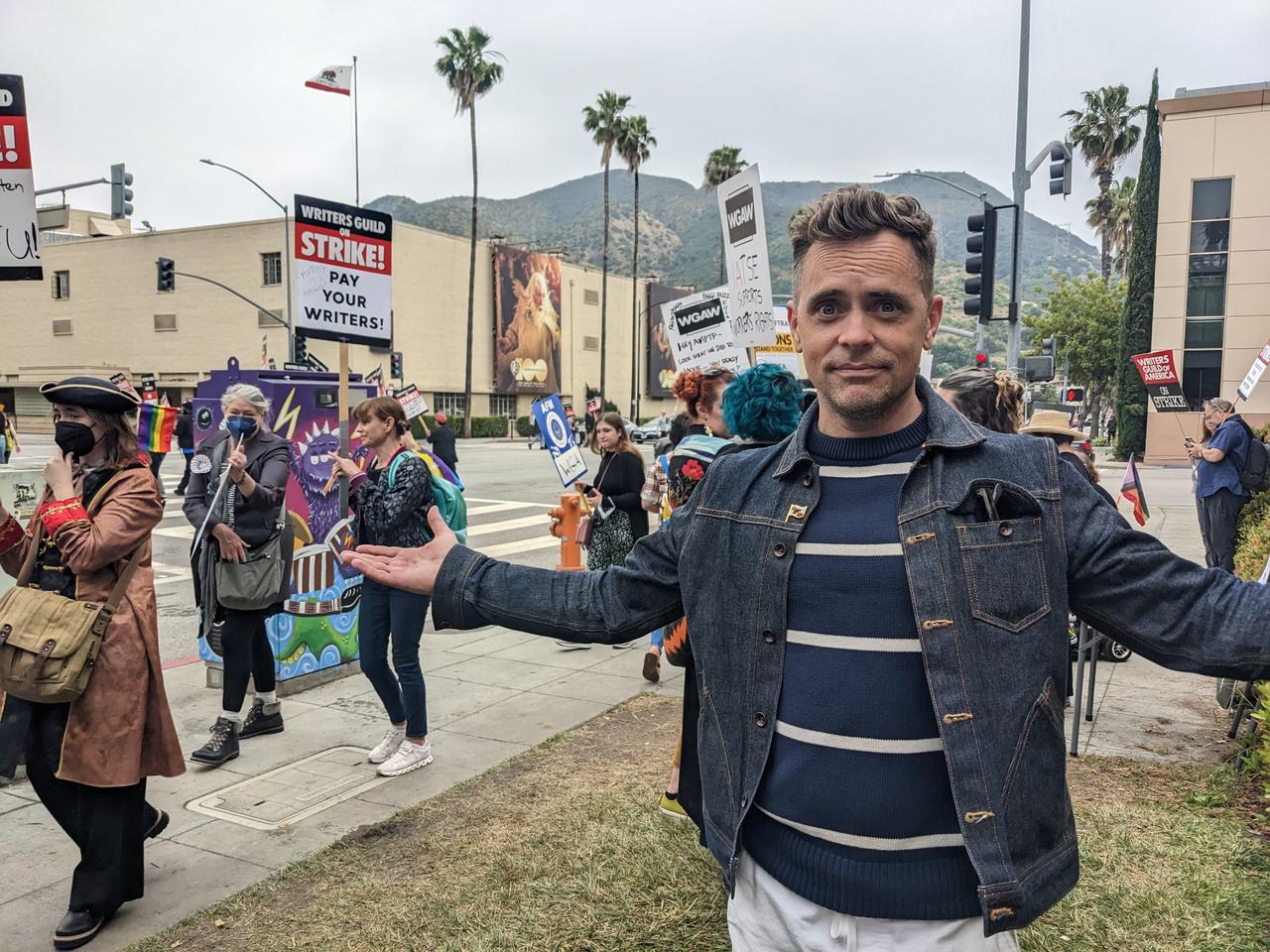 Photograph of David Jenkins in front of strikers wielding picket signs