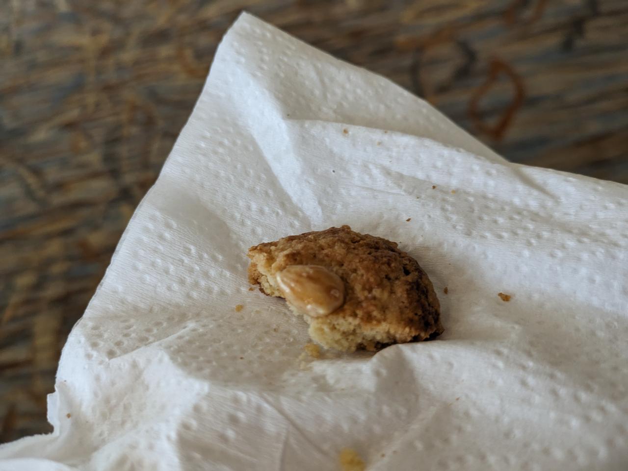 A half-eaten almond cookie