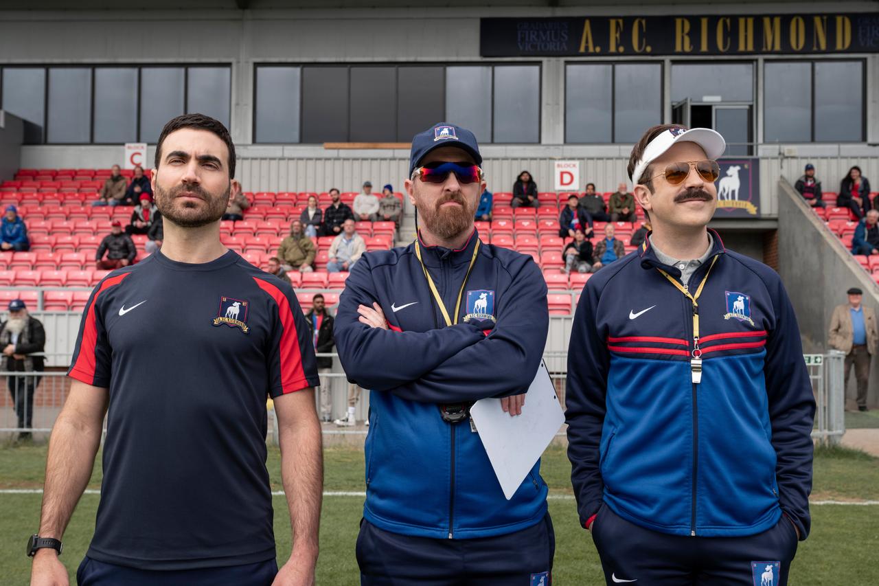 Still photo from Ted Lasso featuring characters Roy Kent, Coach Beard, and Ted Lasso